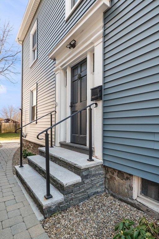 99 Mason Street, Unit 2 Salem, MA 01970 - Photo 24 of 25 a view of a house with a small deck and a floor to ceiling window