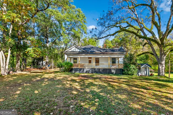 a front view of a house with a garden