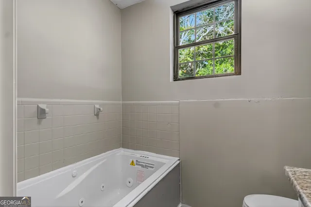 a bathroom with a bathtub and window