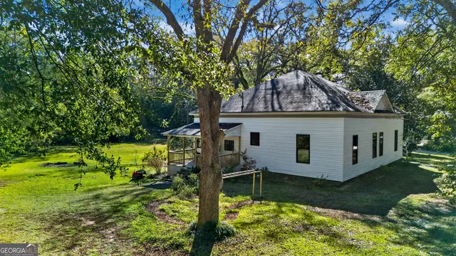 a view of house with backyard