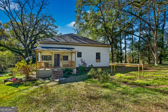 a front view of house with yard and green space