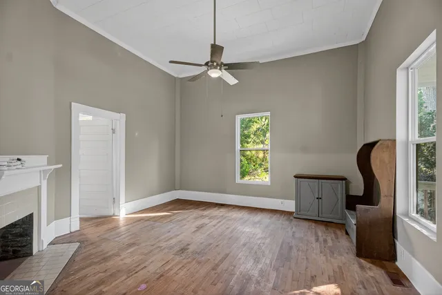 wooden floor in an empty room with a window