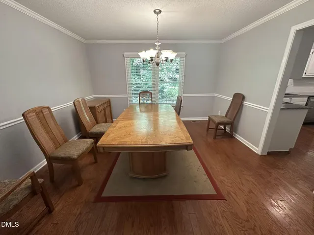 a living room with furniture rug and wooden floor