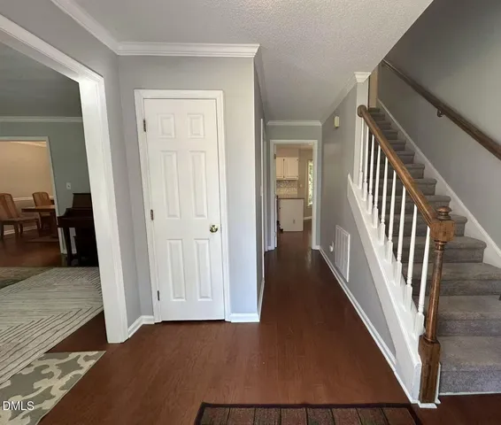a view of a hallway with wooden floor and staircase