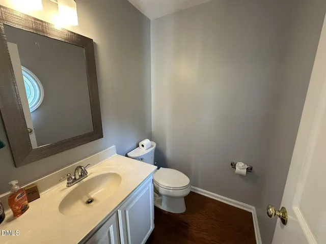 a bathroom with a sink and mirror with toilet
