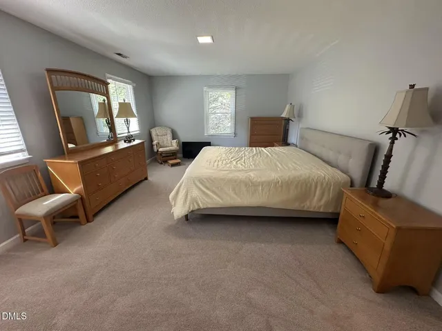 a bedroom with bed and window