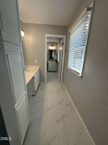 a view of an empty room with a fireplace and a window