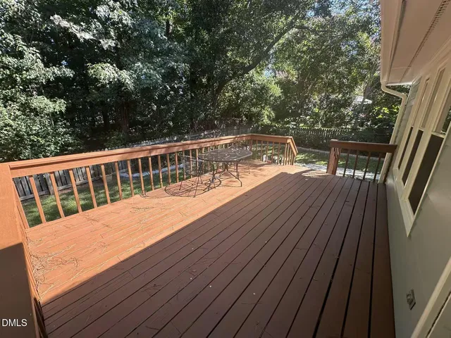 a view of balcony with wooden floor and fence