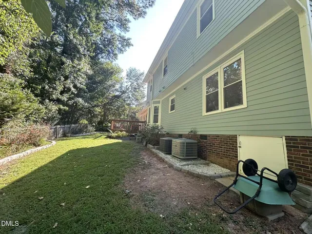 a view of a backyard with table and chairs and wooden fence