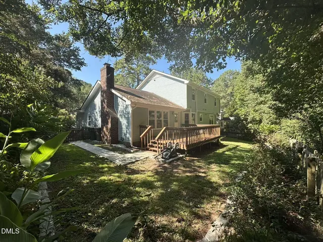 a view of a house with a tree in a yard