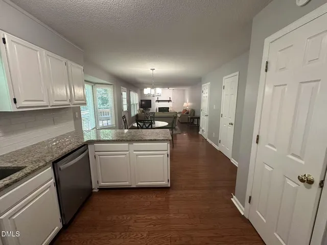 a kitchen with stainless steel appliances granite countertop a refrigerator sink and cabinets