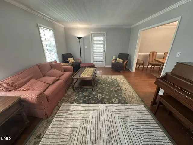 a living room with furniture and a rug