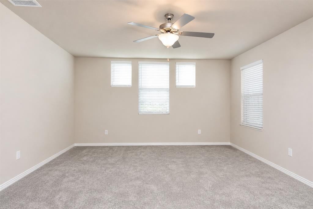 3704 Banton Street Rowlett, TX 75089 - Photo 16 of 16 Spacious room featuring neutral paint, gray carpet, a ceiling fan with integrated lighting, and multiple windows with blinds