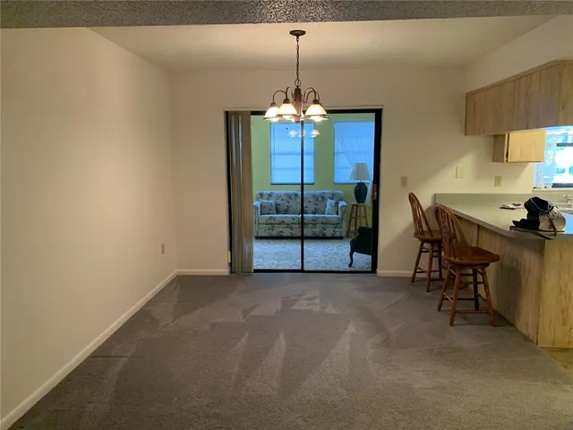 a view of a room with furniture and chandelier