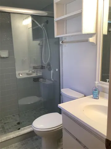a bathroom with a shower and a toilet