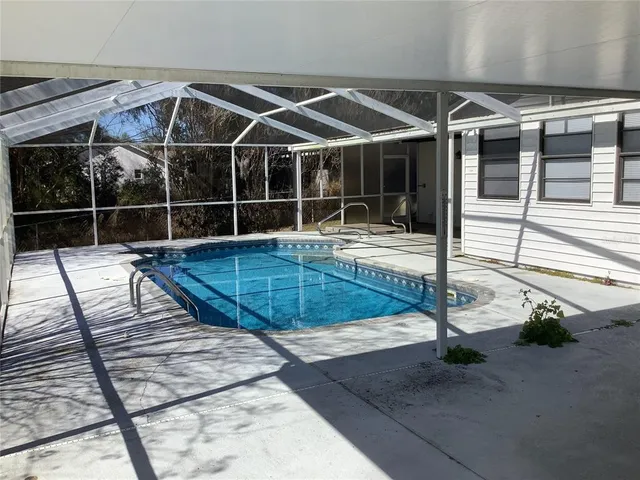 a view of a backyard with swimming pool