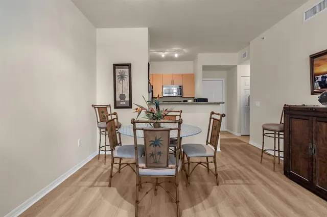 a view of a dining room with furniture and wooden floor
