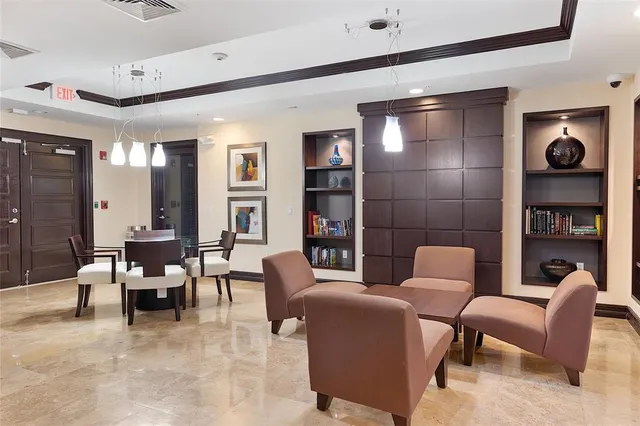 a living room with furniture and a book shelf
