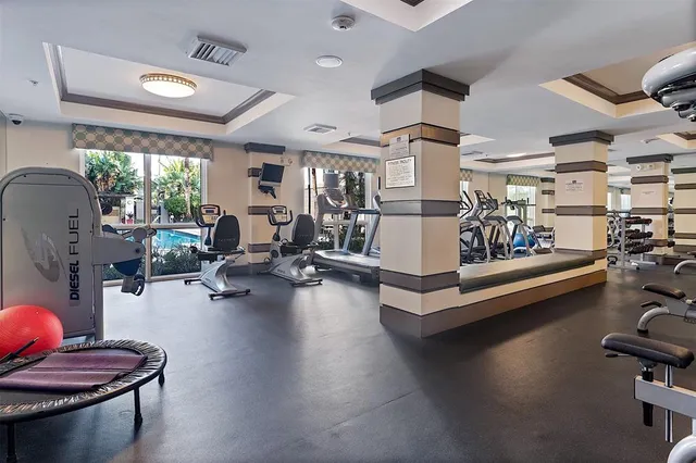 a living room with patio furniture and a large window