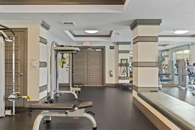 a room with gym equipment and a large window