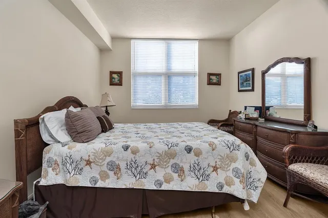 a bedroom with a bed and window