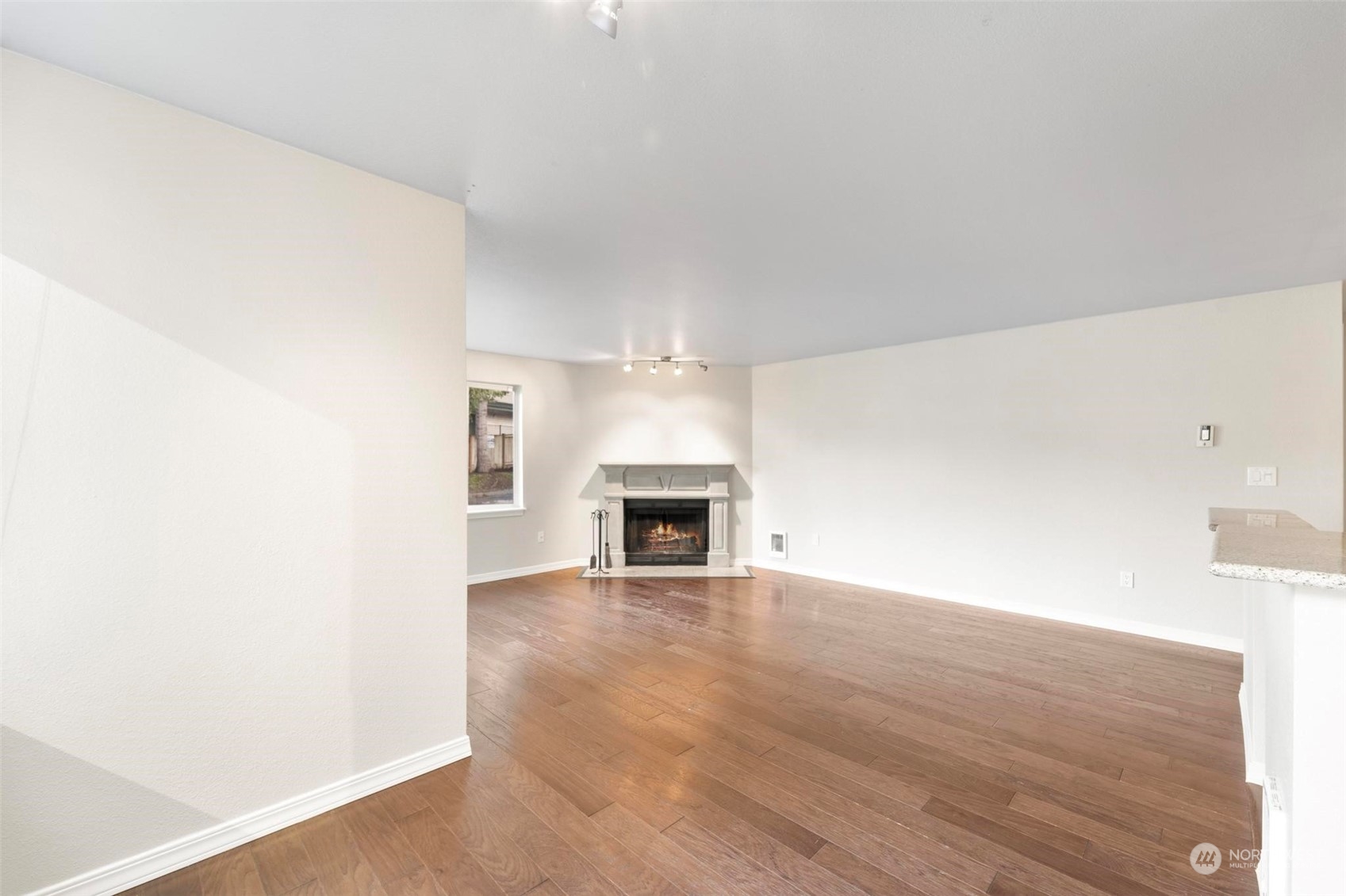20328 Bothell Everett Highway, Unit B101 Bothell, WA 98012 - Photo 8 of 25 a view of a livingroom with a fireplace and window