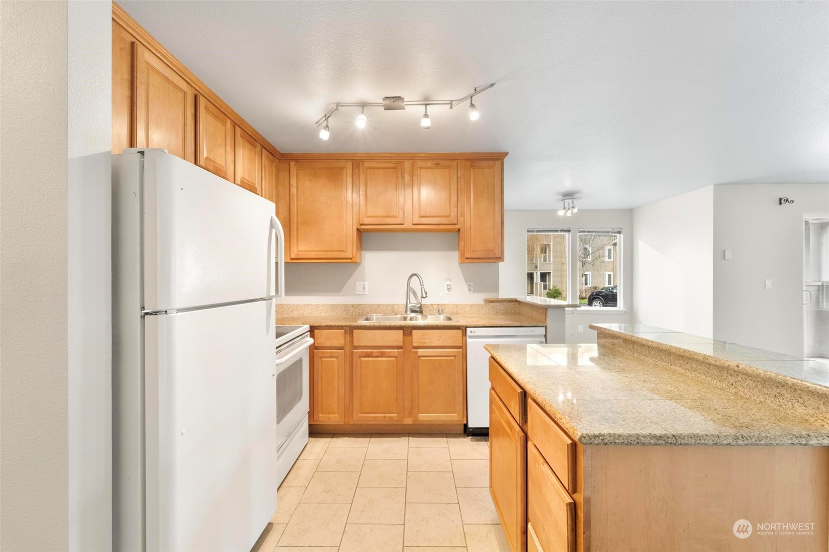 20328 Bothell Everett Highway, Unit B101 Bothell, WA 98012 - Photo 10 of 25 a kitchen with a sink a refrigerator and a stove