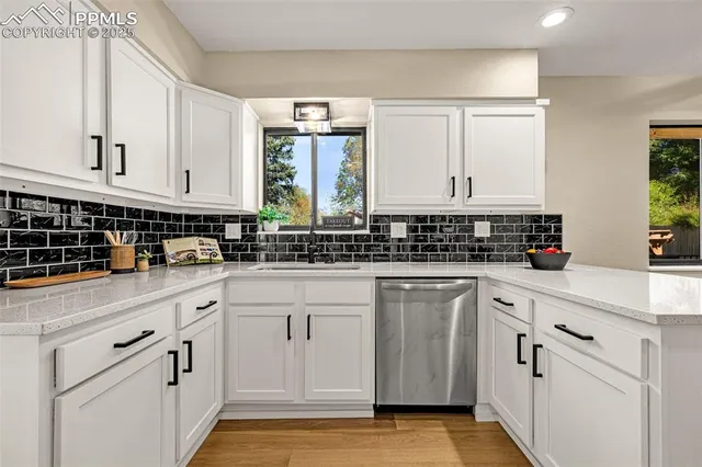 a kitchen with stainless steel appliances granite countertop a stove a sink dishwasher and a refrigerator