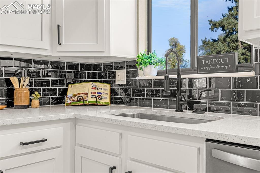 23 Newport Circle Colorado Springs, CO 80906 - Photo 15 of 49 a kitchen with a sink and a potted plant