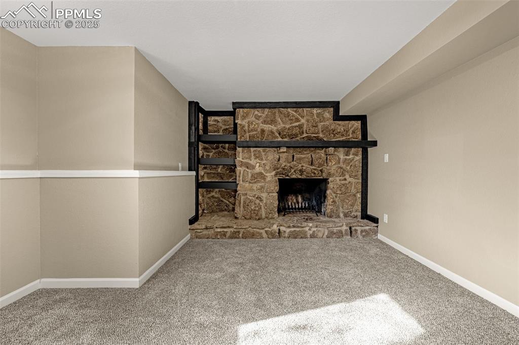 23 Newport Circle Colorado Springs, CO 80906 - Photo 24 of 49 a view of an empty room with a fireplace