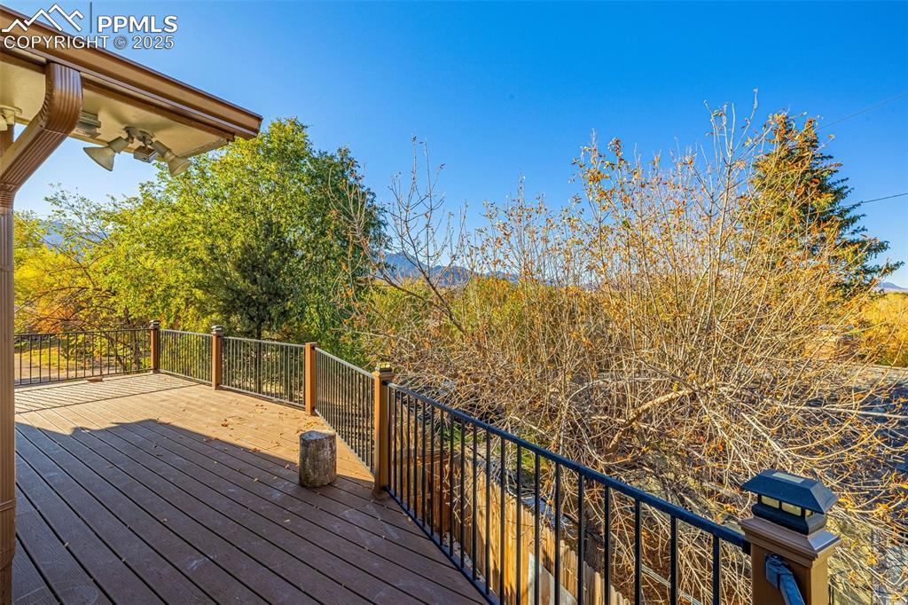 23 Newport Circle Colorado Springs, CO 80906 - Photo 34 of 49 a view of a balcony with wooden floor and a bench