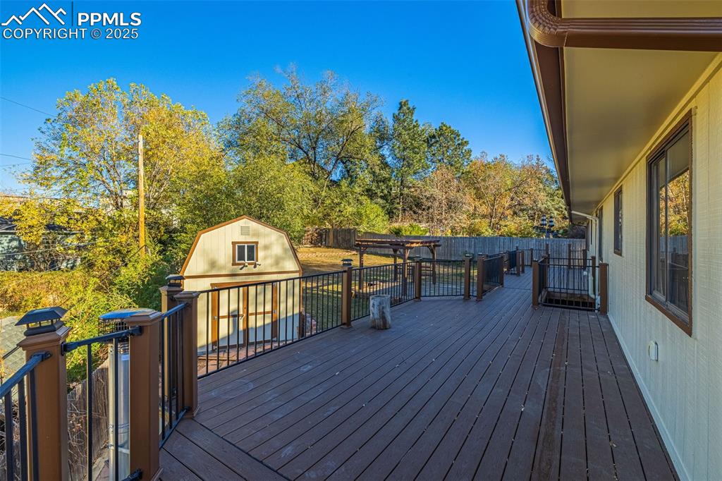 23 Newport Circle Colorado Springs, CO 80906 - Photo 35 of 49 a view of a balcony with wooden floor and fence