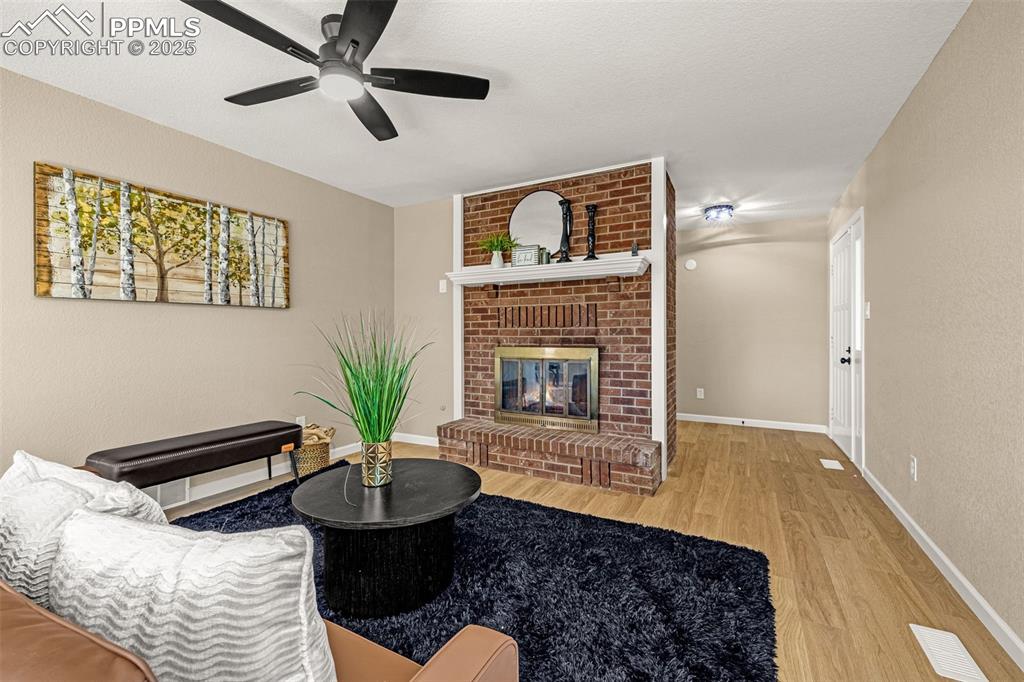 23 Newport Circle Colorado Springs, CO 80906 - Photo 4 of 49 a living room with furniture and a fireplace