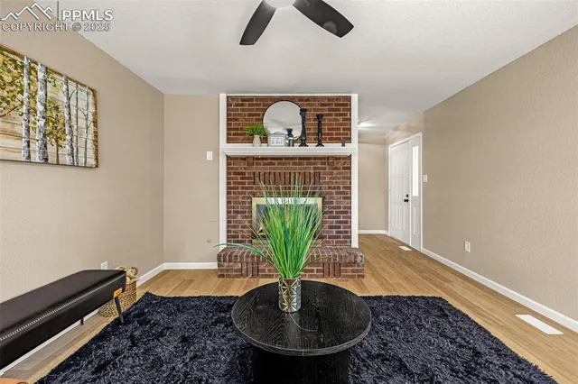 a dining room with furniture and a large window