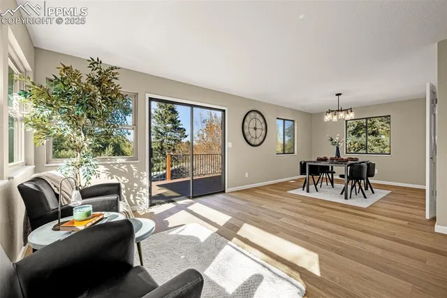 a living room with furniture large window and flat screen tv