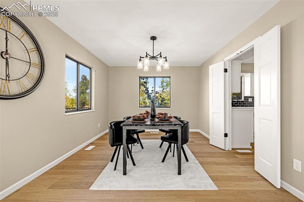 23 Newport Circle Colorado Springs, CO 80906 - Photo 8 of 49 a view of a dining room with furniture window and wooden floor