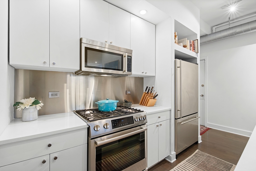 43-45 Winter Street, Unit 4 Boston, MA 02108 - Photo 15 of 24 a kitchen with stainless steel appliances white cabinets and a stove