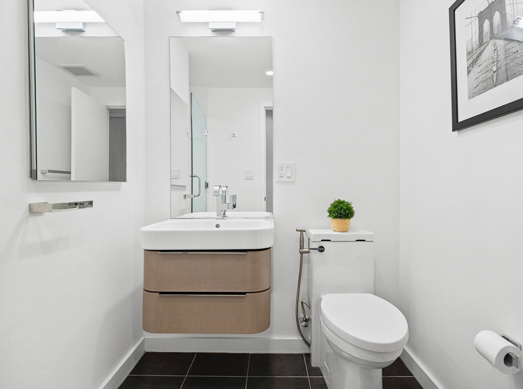 43-45 Winter Street, Unit 4 Boston, MA 02108 - Photo 17 of 24 a bathroom with a sink toilet and a mirror