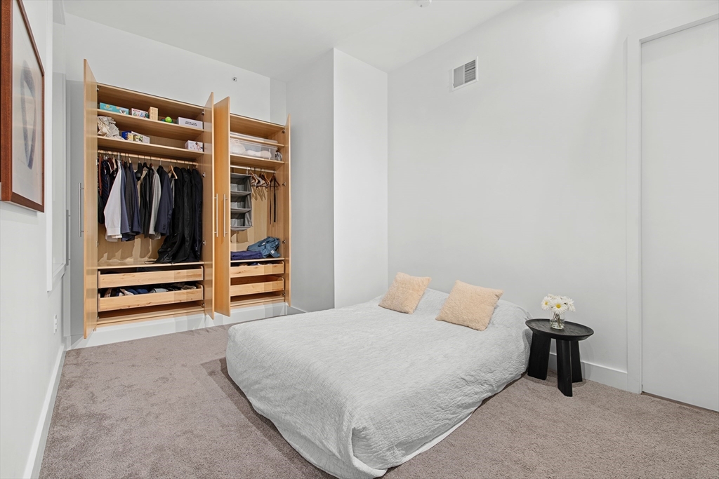 43-45 Winter Street, Unit 4 Boston, MA 02108 - Photo 22 of 24 a bedroom with a bed and a walk in closet
