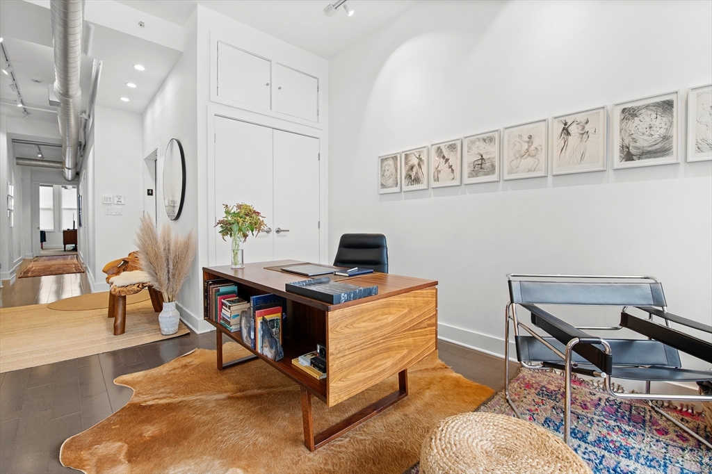 43-45 Winter Street, Unit 4 Boston, MA 02108 - Photo 6 of 24 a workspace with wooden floor and a rug