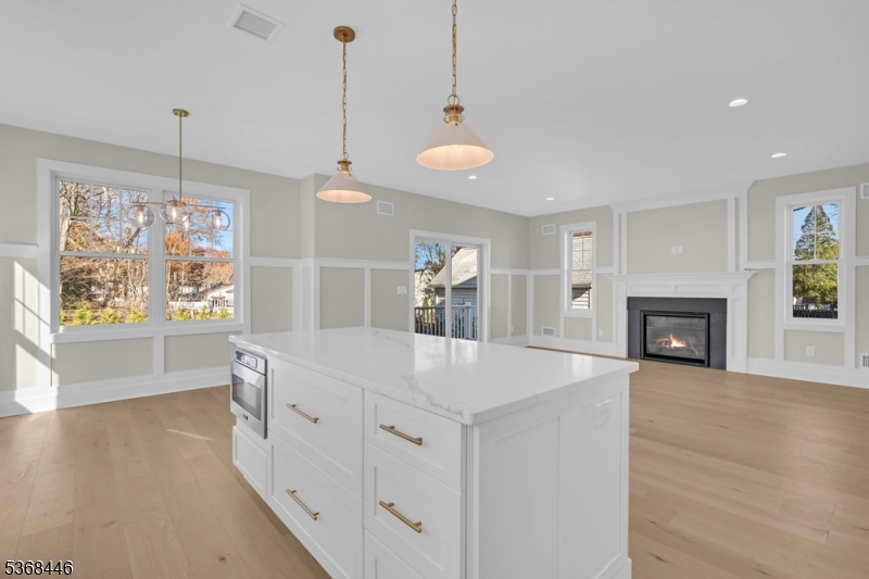 44 Brooklake Road Madison, NJ 07940 - Photo 14 of 44 a view of a kitchen island a chandelier and wooden floor