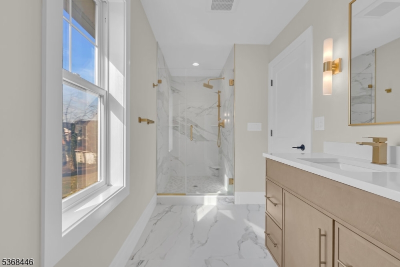 44 Brooklake Road Madison, NJ 07940 - Photo 29 of 44 a spacious bathroom with a shower sink and mirror