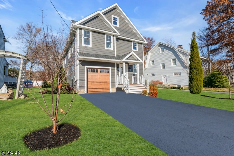 44 Brooklake Road Madison, NJ 07940 - Photo 3 of 44 a front view of a house with a yard and garage