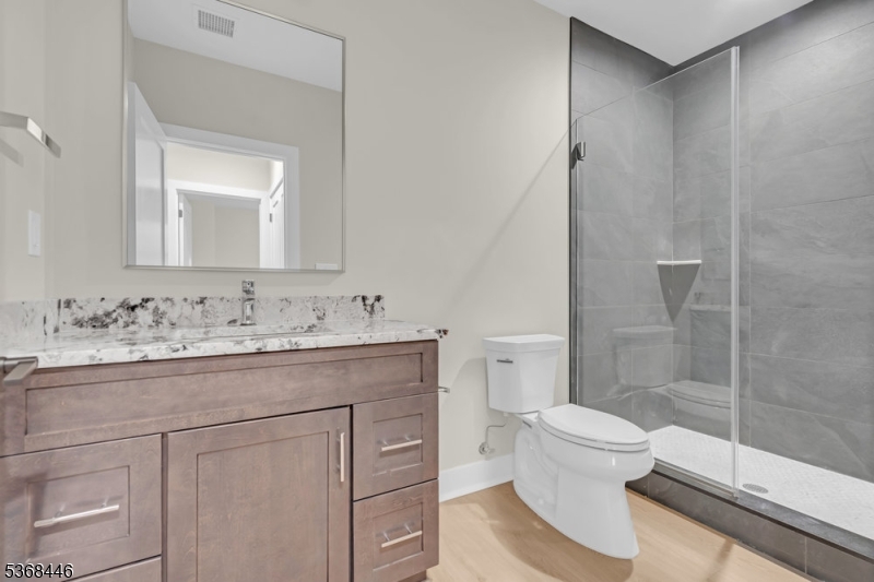 44 Brooklake Road Madison, NJ 07940 - Photo 38 of 44 a bathroom with a granite countertop sink toilet and shower