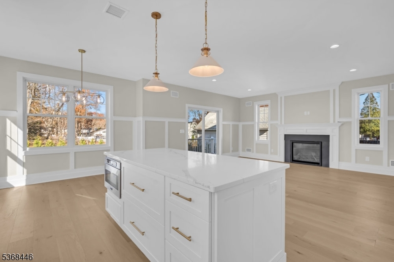 44 Brooklake Road Madison, NJ 07940 - Photo 10 of 44 a view of a kitchen island a chandelier and wooden floor