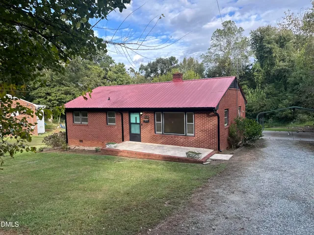 a view of a house with a yard and a garage