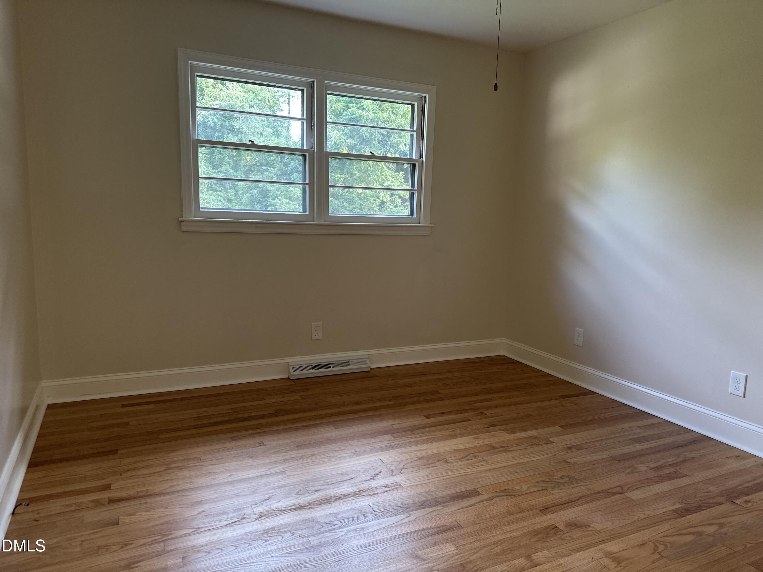 710 North Wilba Road Mebane, NC 27302 - Photo 4 of 7 an empty room with wooden floor and windows