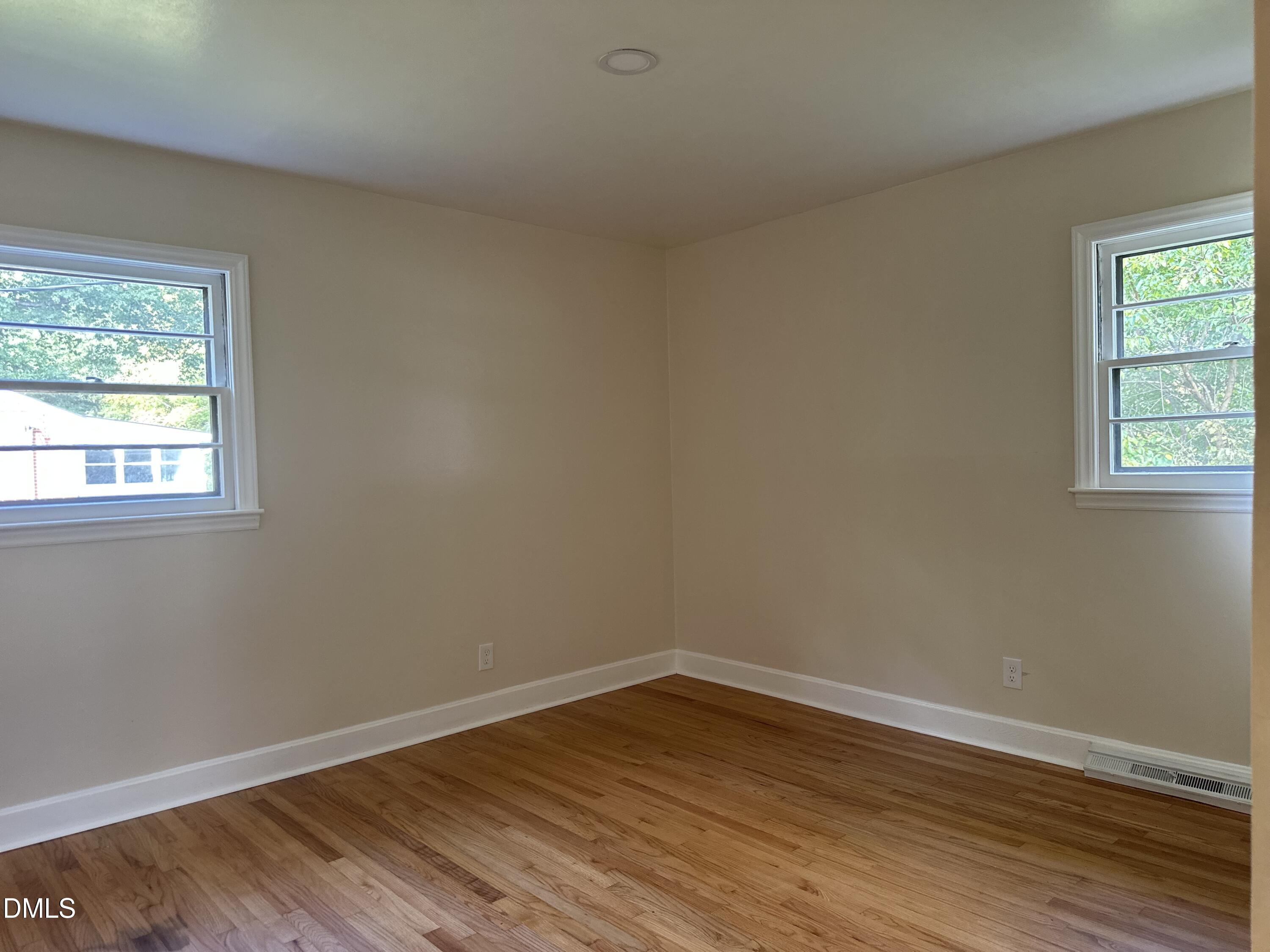 710 North Wilba Road Mebane, NC 27302 - Photo 5 of 7 a view of an empty room with wooden floor and a window