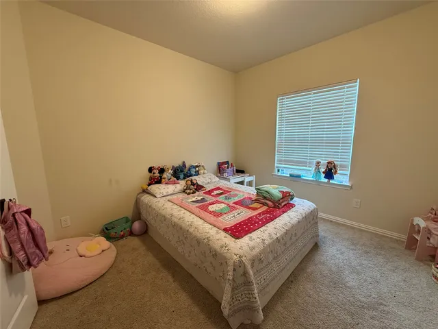 a bedroom with bed and a window