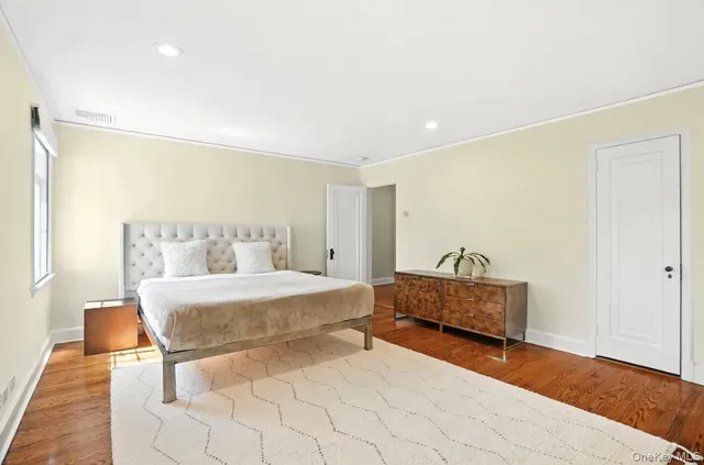 a spacious bedroom with a bed and window